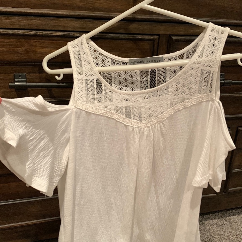 Absolutely Famous lace yoke cold shoulder top with fringe hem